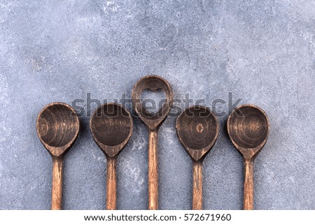 wooden spoon over textured background, from above