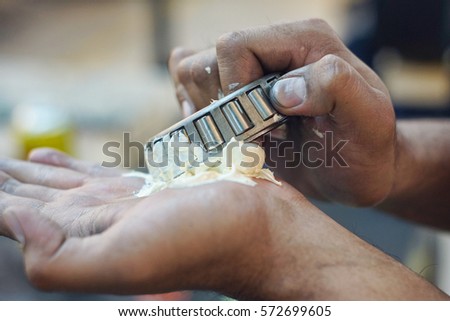 Insert grease into the bearing cone Royalty-Free Stock Photo #572699605