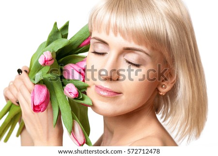 Beautiful girl with clean skin and bouquet of tulips