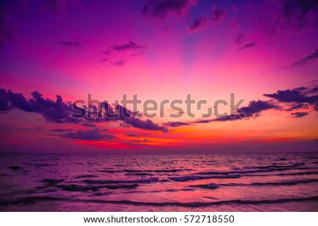 Nature in twilight period which including of sunrise over the sea and the nice beach. Summer beach with blue water and purple sky at the sunset.  Royalty-Free Stock Photo #572718550