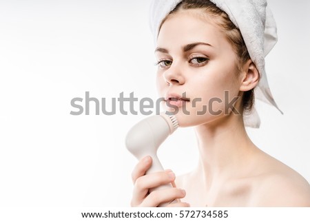 Young Happy woman uses an electric brush for deeply clean on the nose,enjoy expression.Isolated on white