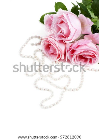 Beautiful pink roses and necklace pearls isolated over white background. Flower bouquet and jewelry for wedding or valentine decoration.