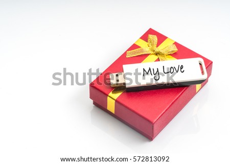 Pendrive with text and red box of gift.