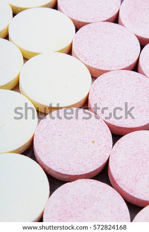 Stack of vitamin mineral supplement effervescent tablets pattern texture. Multivitamin supplement tablet. Soluble Vitamin. Fizzy tablet. Orange flavored effervescent tablets