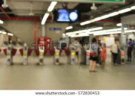 Blurred image of People a the Gate or Ticket barrier at railway of Airport Rail Link train station in Bangkok, night time, Thailand.
