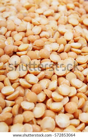 A background of split yellow peas. Yellow peas texture background pattern wallpaper. Healthy food. Studio photo texture photography
