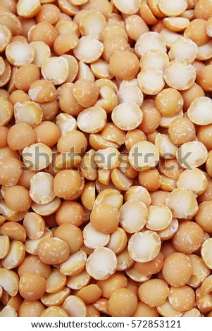 A background of split yellow peas. Yellow peas texture background pattern wallpaper. Healthy food. Studio photo texture photography