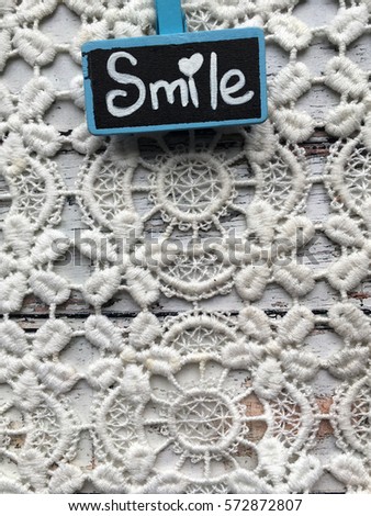 Lace with blue chalkboard. Chalkboard on lace  background with space for  your text. Blue chalkboard with word smile. Positive instagram wallpaper. Valentines morning. 