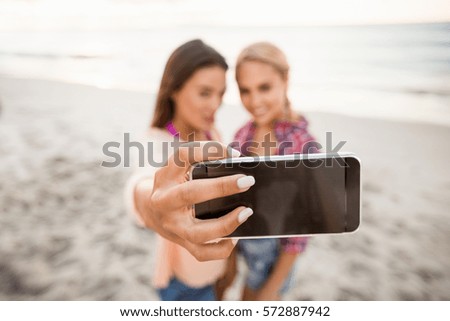 Friends taking a selfie at the beach