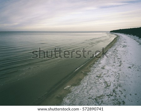aerial view of frozen beach in winter. drone photography. sea with waves. - vintage effect