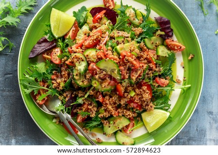 Quinoa tabbouleh salad with tomatoes, cucumber green onion. Concept healthy food