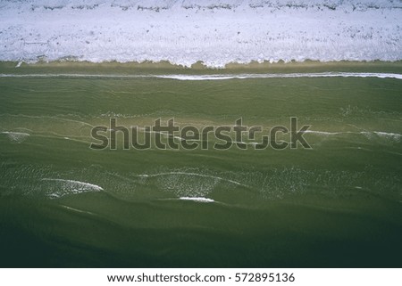 aerial view of frozen beach in winter. drone photography. sea with waves. - vintage effect