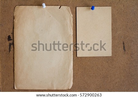 Sheets of paper pinned to the plywood.