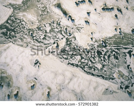 aerial view of frozen forest lake in winter. drone photography. abstract texture - vintage effect