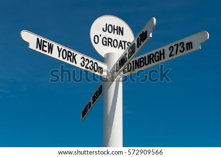 The milepost sign at John O Groats in Scotland on the most north eastern tip of the UK Royalty-Free Stock Photo #572909566
