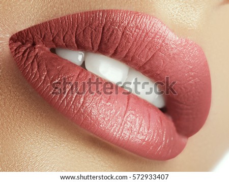 Perfect natural lip makeup. Close up macro photo with beautiful female mouth. Plump full lips. Close-up face detail. Perfect clean skin, light fresh lip make-up. Beautiful spa tender lip Royalty-Free Stock Photo #572933407