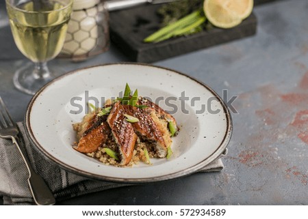 grilled eel with quinoa on the plate, lunch at Japanese or Asian style