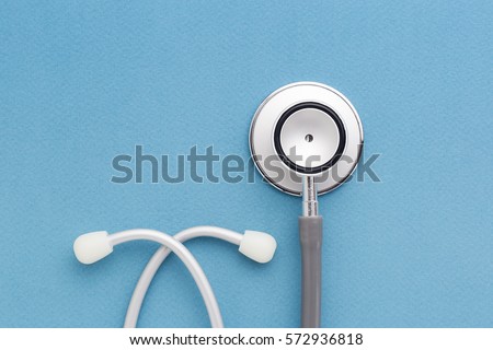 Stethoscope on blue background Royalty-Free Stock Photo #572936818