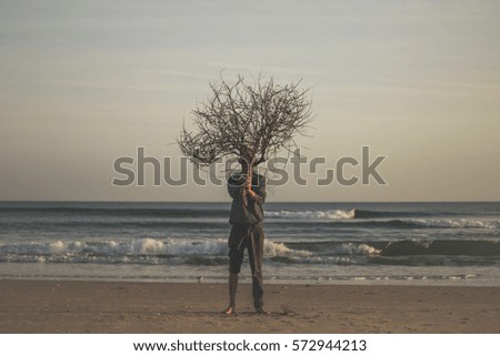 A man holding a twig