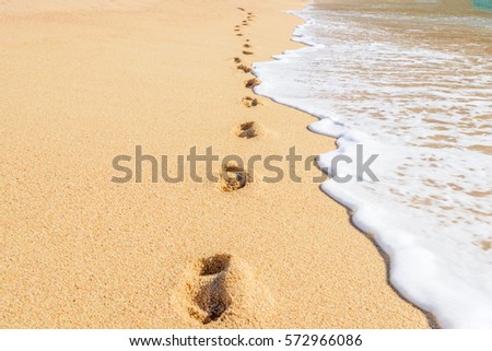 Footprints on the beautiful ocean sand. Set of six pictures showing ocean waves in different stages over footprints. Cabo San Lucas. Mexico.