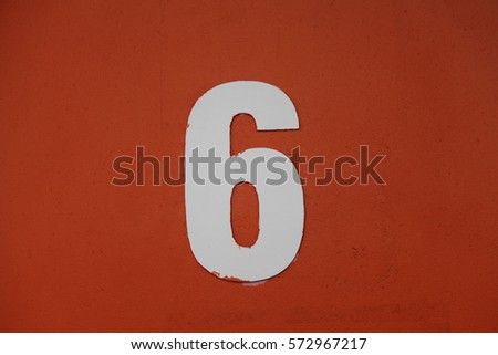 White number six or nine on an orange background