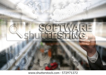 Businessman draws "Software Testing" on the virtual screen. Touch Screen. Virtual Icon. Graphs Interface. Business concept. Internet concept. Digital Interfaces