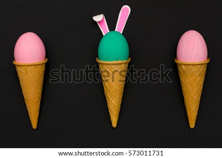 eggs in waffle cones on a black background. festive Easter decoration concept. flat lay.