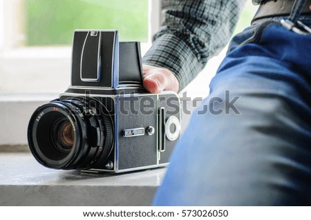 man holding old photocamera