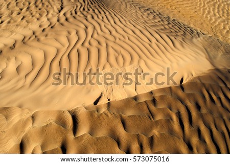 Brown color. Natural texture and background of the desert. Sand patterns