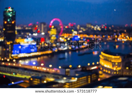 City of London at sunset with lights and reflection. View at the business and banking aria with modern skyscrapers. Blurred image for background