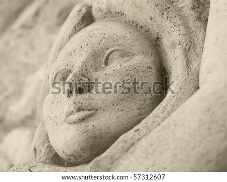 Detail of a statue of a woman carved on the wall.