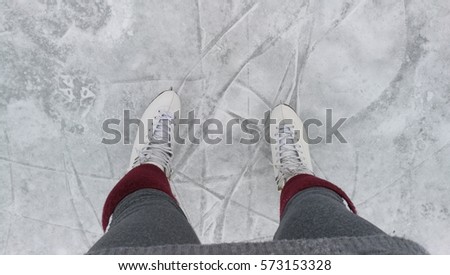 white ice skates on ice in winter