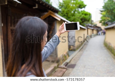 Woman taking selfie by mobile phone
