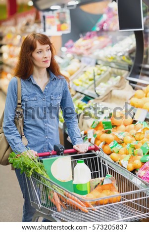 Customer walking around the supermarket with a trolley