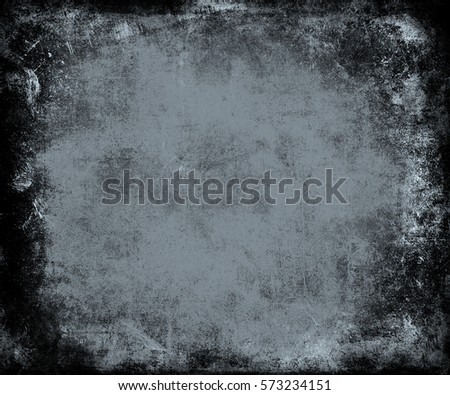 Abstract grungy blue texture with frame and faded central area for your text or picture useful as background.