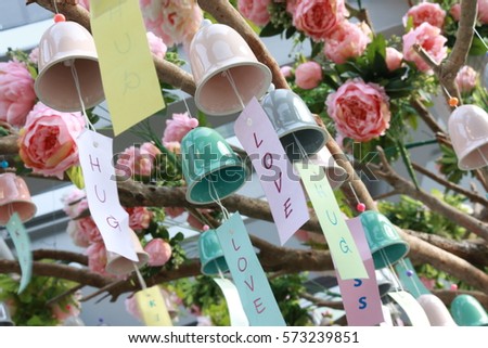 colorful wind Chimes hang on tree, wish paper on wind Chime , balcony decoration, happy valentine day, sign of love, nice holiday,colorful background 