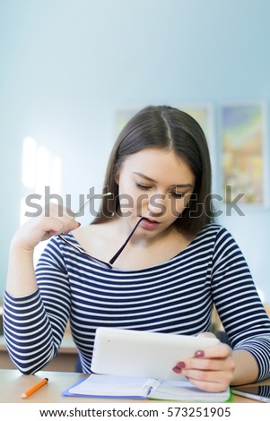 girl rejoices at the table in a light room