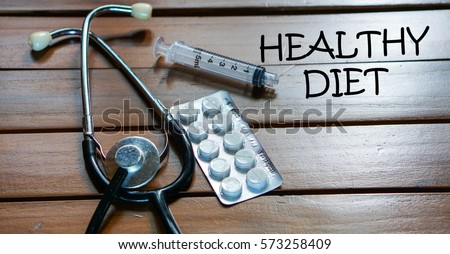 HEALTHY DIET  written on wooden table .Medical and health care concept