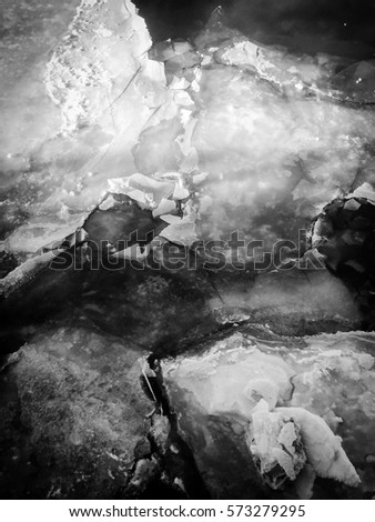 Ice and rocks look like marble. Royalty-Free Stock Photo #573279295