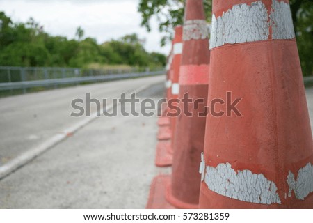 Row of orange Traffic cone on gray asphalt