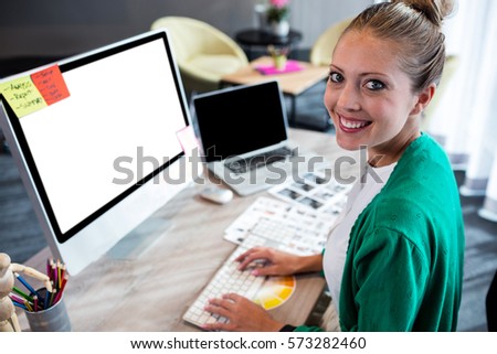 Casual businesswoman using a computer in the office