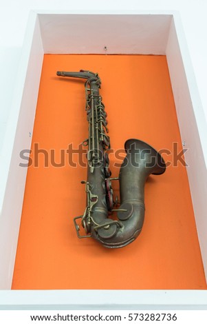 Saxophone on orange color background