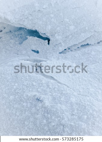 Sheets of snow are texture on a white background. Royalty-Free Stock Photo #573285175