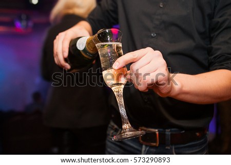Pouring a glass of champagne