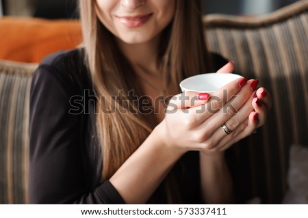 woman hands holding cup of hot drink