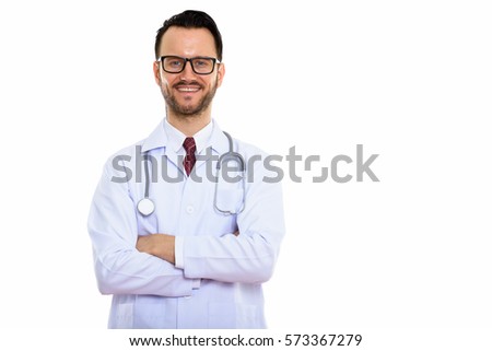 Studio shot of happy young man doctor smiling with arms crossed