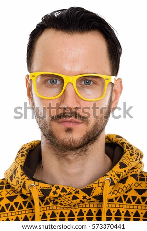 Face of young man wearing yellow eyeglasses