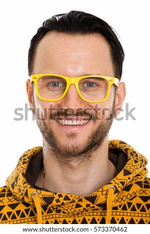 Face of happy young man smiling while wearing yellow eyeglasses