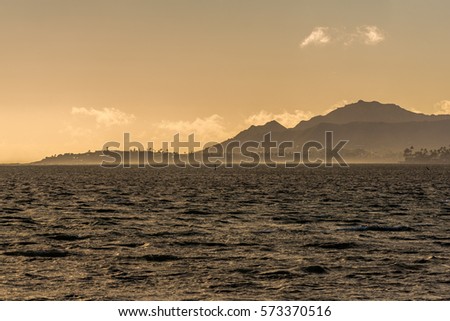 Sunset view on a windy day of Diamond Head crater and black point peninsula, taken from Maunalua Bay in Hawaii Kai, Oahu, Hawaii