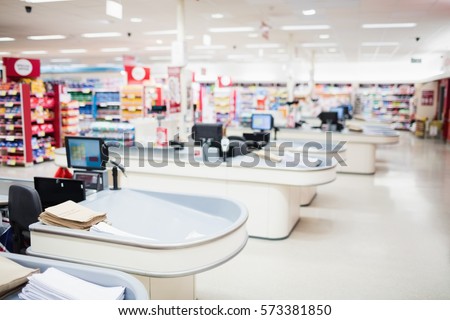 View of tills and shelves in the supermarket Royalty-Free Stock Photo #573381850